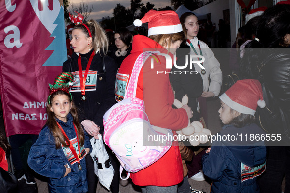 People wearing Santa Claus costumes participate in the annual Santa Run in Athens, Greece, on December 14, 2024. 