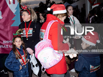 People wearing Santa Claus costumes participate in the annual Santa Run in Athens, Greece, on December 14, 2024. (