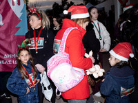 People wearing Santa Claus costumes participate in the annual Santa Run in Athens, Greece, on December 14, 2024. (