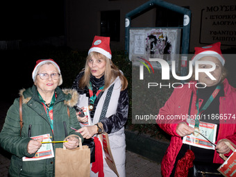 People wearing Santa Claus costumes participate in the annual Santa Run in Athens, Greece, on December 14, 2024. (