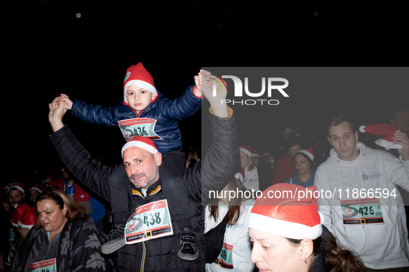 People wearing Santa Claus costumes participate in the annual Santa Run in Athens, Greece, on December 14, 2024. 