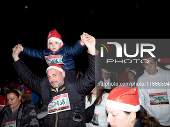 People wearing Santa Claus costumes participate in the annual Santa Run in Athens, Greece, on December 14, 2024. (