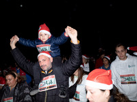 People wearing Santa Claus costumes participate in the annual Santa Run in Athens, Greece, on December 14, 2024. (