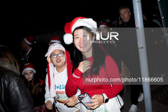 People wearing Santa Claus costumes participate in the annual Santa Run in Athens, Greece, on December 14, 2024. 