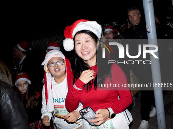 People wearing Santa Claus costumes participate in the annual Santa Run in Athens, Greece, on December 14, 2024. (