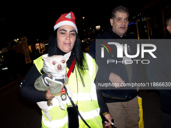 People wearing Santa Claus costumes participate in the annual Santa Run in Athens, Greece, on December 14, 2024. (