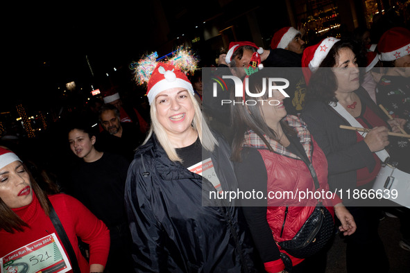 People wearing Santa Claus costumes participate in the annual Santa Run in Athens, Greece, on December 14, 2024. 