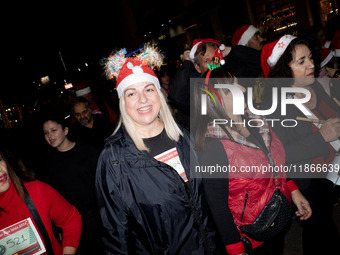 People wearing Santa Claus costumes participate in the annual Santa Run in Athens, Greece, on December 14, 2024. (