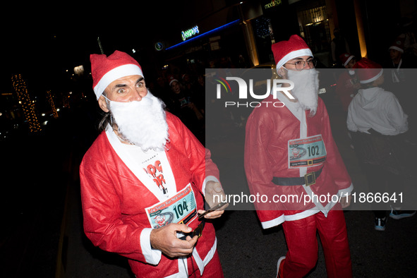 People wearing Santa Claus costumes participate in the annual Santa Run in Athens, Greece, on December 14, 2024. 