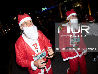 People wearing Santa Claus costumes participate in the annual Santa Run in Athens, Greece, on December 14, 2024. (