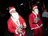 People wearing Santa Claus costumes participate in the annual Santa Run in Athens, Greece, on December 14, 2024. (