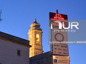 The photo shows the display marking the beginning of the Limited Traffic Zone (ZTL) in the historic center of Locorotondo, Bari. The sign in...