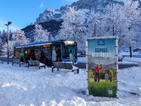 Passengers wait for the bus to Grainau amidst the snowy landscape at Lake Eibsee in Bavaria, Germany, on December 13, 2024. A group of peopl...