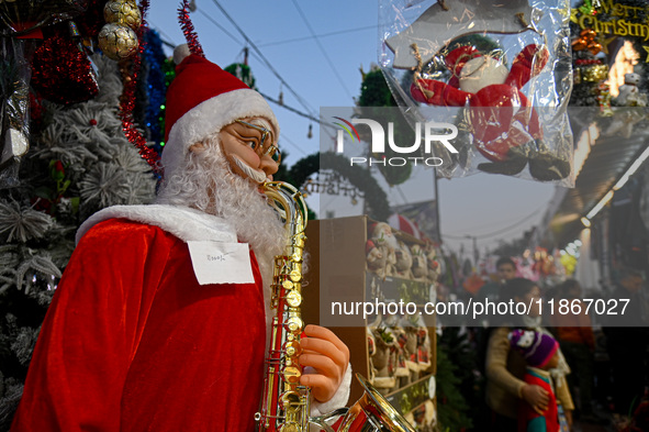 A Santa Claus decorative article is displayed at a stall at a market in New Delhi, India, on December 14, 2024. 