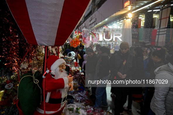 A Santa Claus decorative article is displayed at a stall at a market in New Delhi, India, on December 14, 2024. 