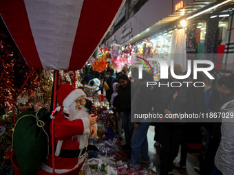 A Santa Claus decorative article is displayed at a stall at a market in New Delhi, India, on December 14, 2024. (