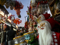 People walk past a stall with decorative articles ahead of the Christmas celebrations in New Delhi, India, on December 14, 2024. (