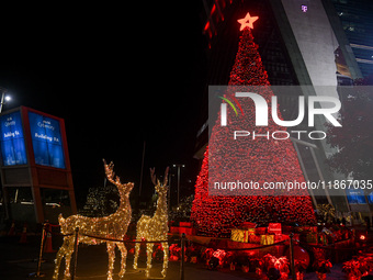 A Christmas tree with decorative lights is visible on a road in Gurugram, India, on December 14, 2024. (