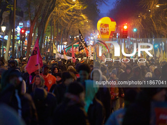 A demonstration against repressive migration policies gathers several hundred people in Paris, France, on December 14. Protesters march thro...