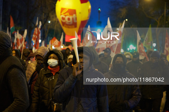 A demonstration against repressive migration policies gathers several hundred people in Paris, France, on December 14. Protesters march thro...