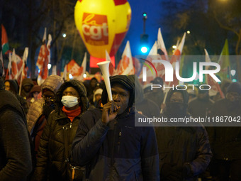 A demonstration against repressive migration policies gathers several hundred people in Paris, France, on December 14. Protesters march thro...