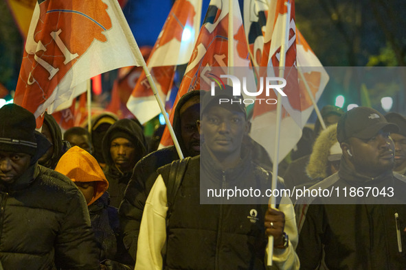 A demonstration against repressive migration policies gathers several hundred people in Paris, France, on December 14. Protesters march thro...