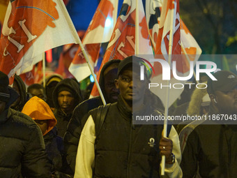 A demonstration against repressive migration policies gathers several hundred people in Paris, France, on December 14. Protesters march thro...