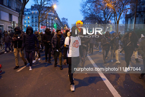 A demonstration against repressive migration policies gathers several hundred people in Paris, France, on December 14. Protesters march thro...