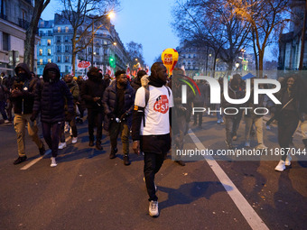 A demonstration against repressive migration policies gathers several hundred people in Paris, France, on December 14. Protesters march thro...