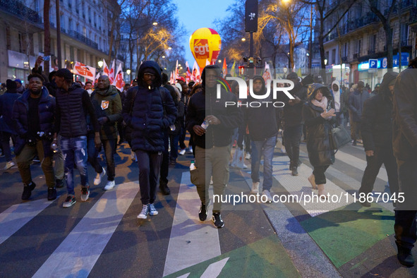 A demonstration against repressive migration policies gathers several hundred people in Paris, France, on December 14. Protesters march thro...