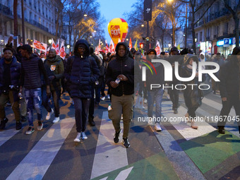 A demonstration against repressive migration policies gathers several hundred people in Paris, France, on December 14. Protesters march thro...