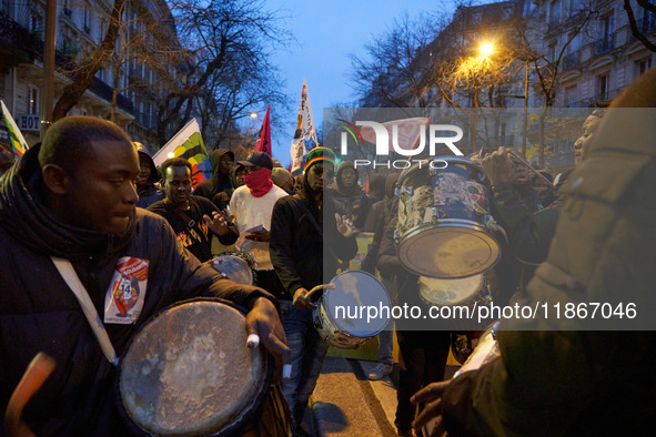 A demonstration against repressive migration policies gathers several hundred people in Paris, France, on December 14. Protesters march thro...