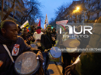 A demonstration against repressive migration policies gathers several hundred people in Paris, France, on December 14. Protesters march thro...