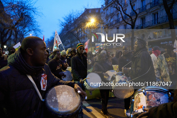 A demonstration against repressive migration policies gathers several hundred people in Paris, France, on December 14. Protesters march thro...