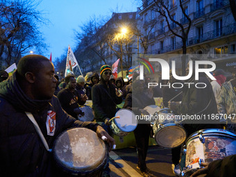 A demonstration against repressive migration policies gathers several hundred people in Paris, France, on December 14. Protesters march thro...