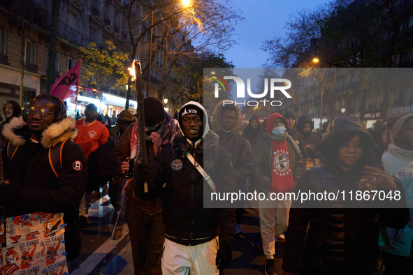 A demonstration against repressive migration policies gathers several hundred people in Paris, France, on December 14. Protesters march thro...