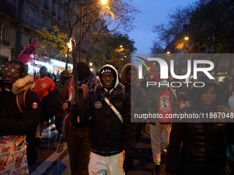 A demonstration against repressive migration policies gathers several hundred people in Paris, France, on December 14. Protesters march thro...