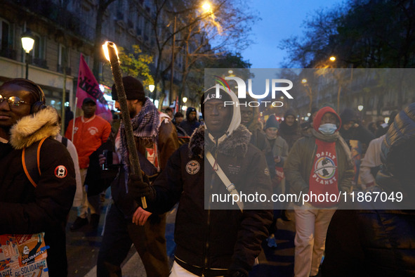 A demonstration against repressive migration policies gathers several hundred people in Paris, France, on December 14. Protesters march thro...