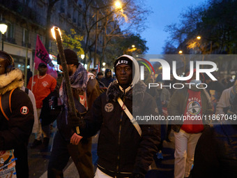 A demonstration against repressive migration policies gathers several hundred people in Paris, France, on December 14. Protesters march thro...