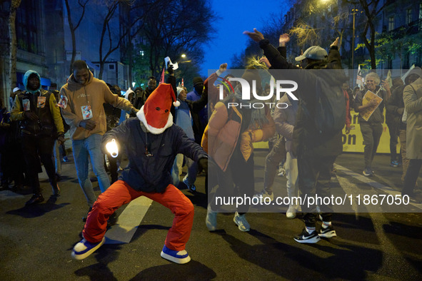 A demonstration against repressive migration policies gathers several hundred people in Paris, France, on December 14. Protesters march thro...