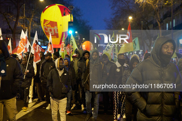 A demonstration against repressive migration policies gathers several hundred people in Paris, France, on December 14. Protesters march thro...