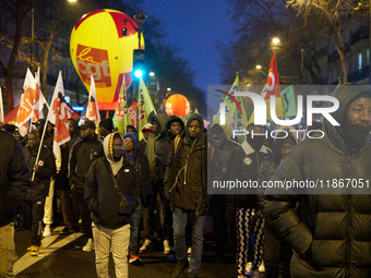 A demonstration against repressive migration policies gathers several hundred people in Paris, France, on December 14. Protesters march thro...