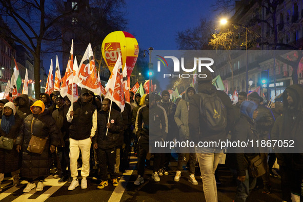 A demonstration against repressive migration policies gathers several hundred people in Paris, France, on December 14. Protesters march thro...