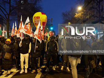 A demonstration against repressive migration policies gathers several hundred people in Paris, France, on December 14. Protesters march thro...