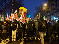 A demonstration against repressive migration policies gathers several hundred people in Paris, France, on December 14. Protesters march thro...