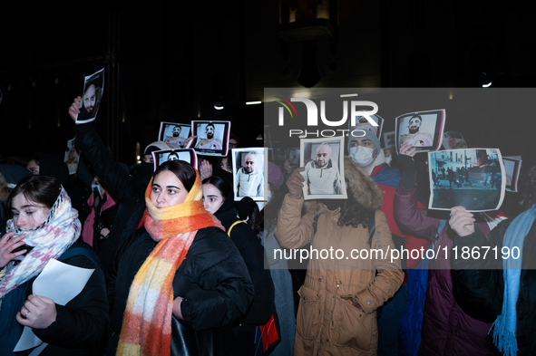 Anti-government demonstrators gather outside the Georgian parliament after the parliament members elect a new president in Tbilisi, Georgia,...