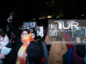 Anti-government demonstrators gather outside the Georgian parliament after the parliament members elect a new president in Tbilisi, Georgia,...