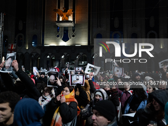 Anti-government demonstrators gather outside the Georgian parliament after the parliament members elect a new president in Tbilisi, Georgia,...