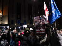 Anti-government demonstrators gather outside the Georgian parliament after the parliament members elect a new president in Tbilisi, Georgia,...