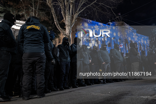 Police officers block the Georgian Parliament building as anti-government demonstrators gather outside the parliament in Tbilisi, Georgia, o...